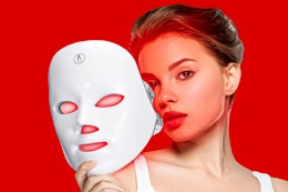 woman holding up the RUTAWZ Led Face Mask in front of her face