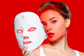 woman holding up the RUTAWZ Led Face Mask in front of her face