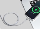 a nylon charging cord connected to an iPhone