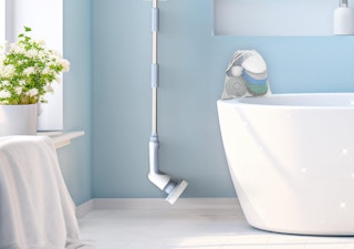 an electric scrubber on a bathroom wall