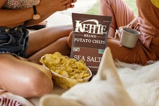 people eating chips from a bowl