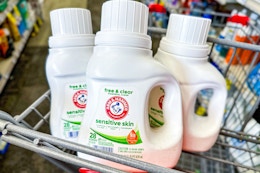 3 bottles of laundry detergent in a cart