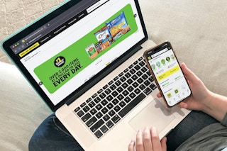 a person looking at the Dollar General app on their phone and the Dollar General website on their laptop