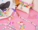colorful bracelets and beads on a pink background