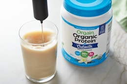 Orgain protein powder being used in drink