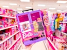 hand holding a barbie ultimate closet in a target aisle