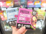 2 Pitaya Foods Smoothie Bowls held up in freezer aisle in Walmart store