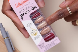 a woman holding sally hansen nails