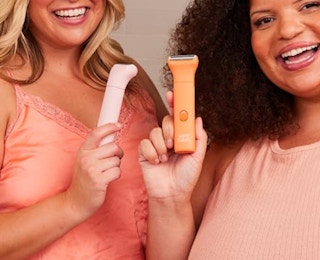 two women holding bikini trimmers