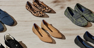 Pairs of Rothy's shoes lined up on a wooden floor
