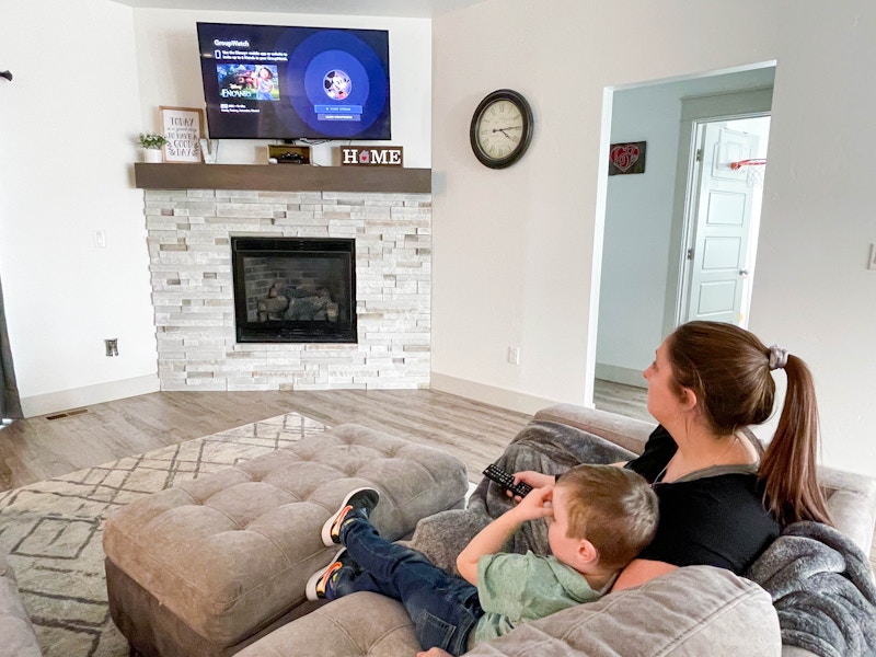 mother and child watching disney plus in living room