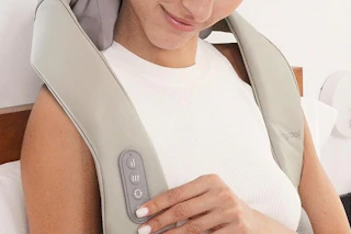 a woman using a neck massager