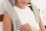 a woman using a neck massager