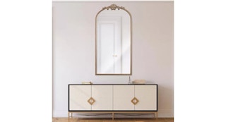gold mirror above a table