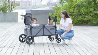 A mom with her kids sitting in a Jeep Wrangler Stroller Wagon