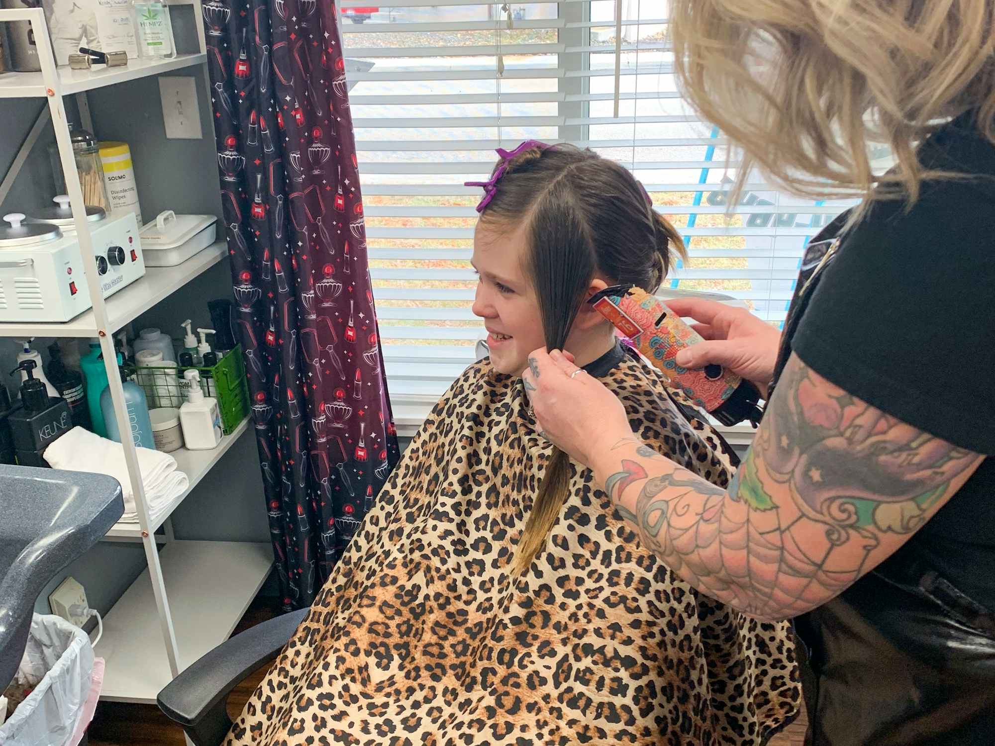 a child getting a haircut at a salon