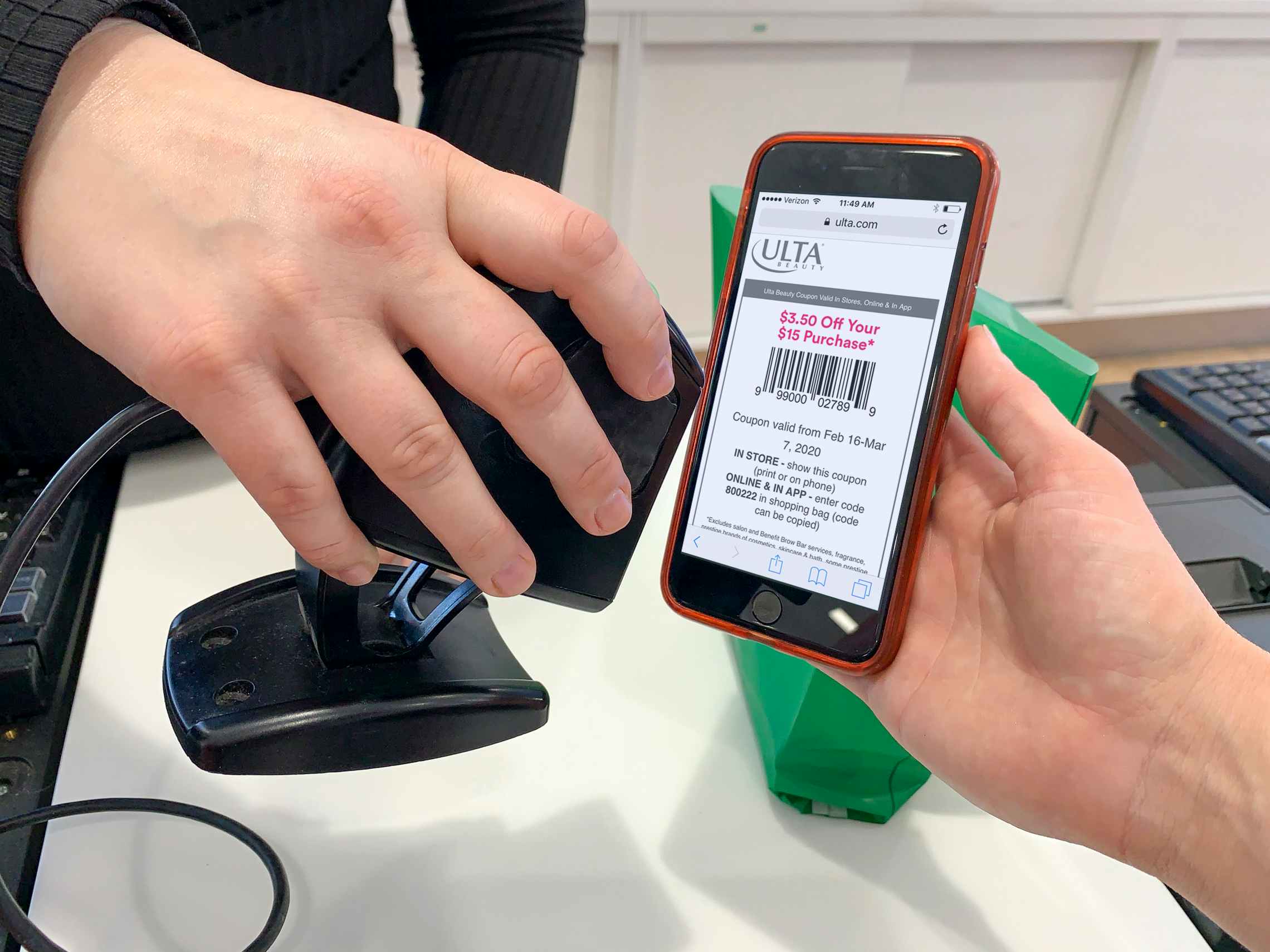 An ulta employee scanning a mobile coupon at checkout.