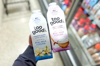 hand holding 2 bottles of too good & co coffee creamer at target