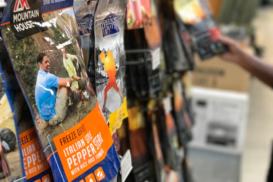 Bags of freeze dried food hanging on a display at REI.