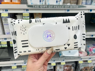 hand holding honest co baby wipes
