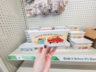 hand holding a mini loaf pan that says fresh picked apples