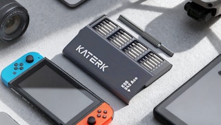 a screwdriver set next to a Nintendo Switch