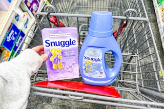 person placing snuggle dryer sheets in a cart with fabric softener