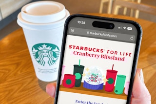 starbucks for life game on a phone next to a starbucks cup