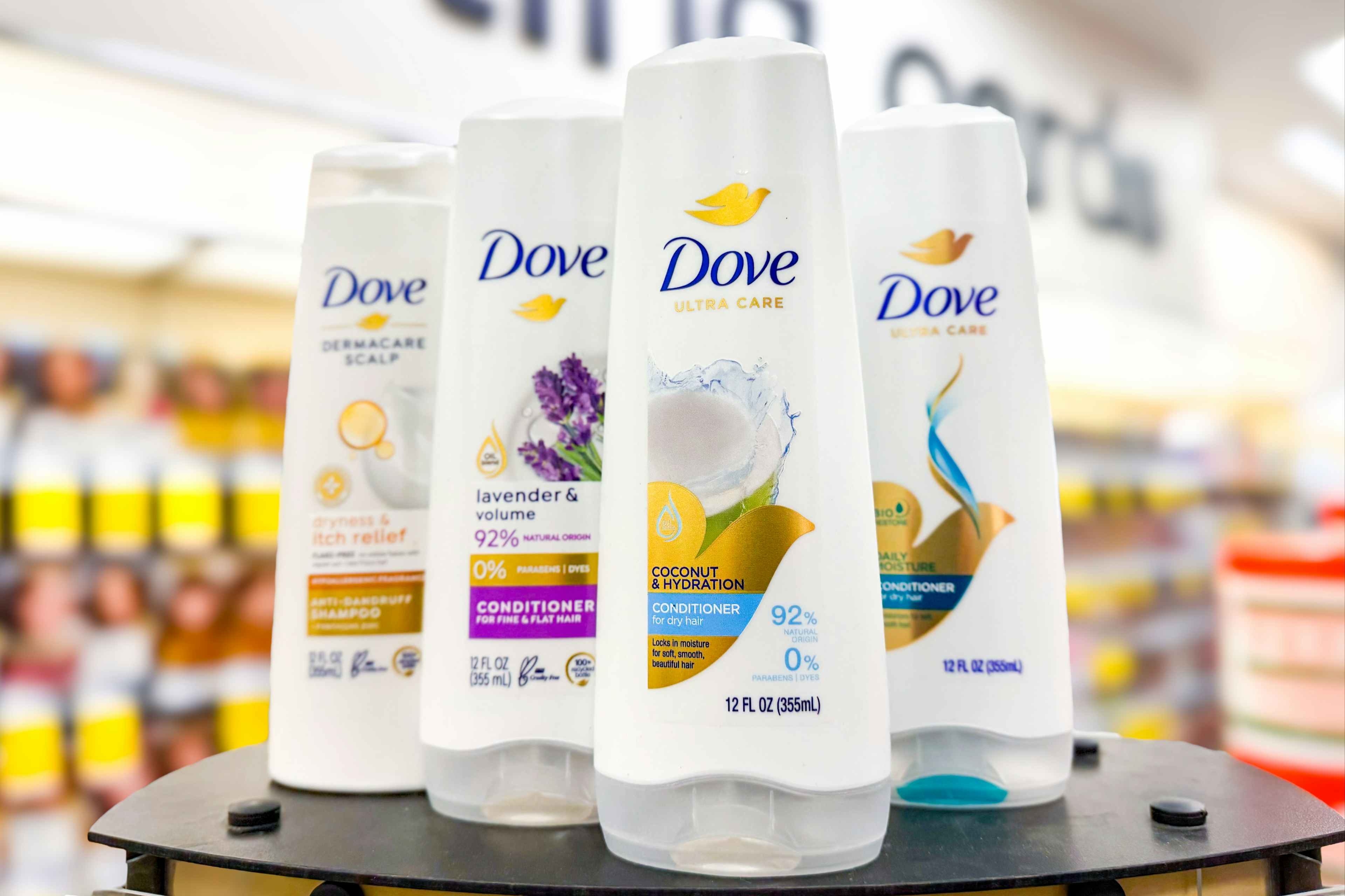 four bottles of dove hair care
