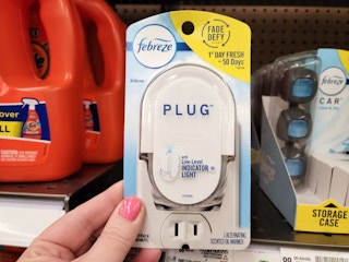 hand holding a febreze plug warmer