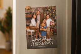 a christmas card on a fridge 