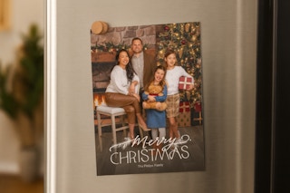 a christmas card on a fridge 
