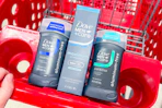 hand pushing a shopping cart with Dove Men+Care deodorants
