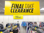 A large JCPenney clearance sign hanging above racks of clothing.