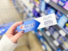 hand holding crest prohealth toothpaste in walmart aisle