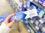 hand holding crest prohealth toothpaste in walmart aisle