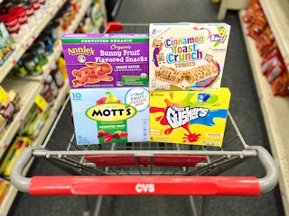 box of Annie's, Mott's, Fruit Gushers, and Cinnamon Toast Crunch treats inside shopping cart