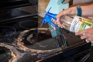 Glasstop stove being cleaned with Vinegar
