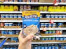 hand holding progresso soup in walmart aisle