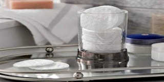 A package of cotton rounds in a container.