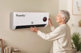 Woman setting her Thawify Electric Space Heater.