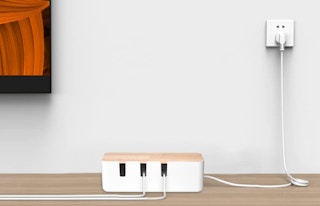 White box with cables next to an outlet