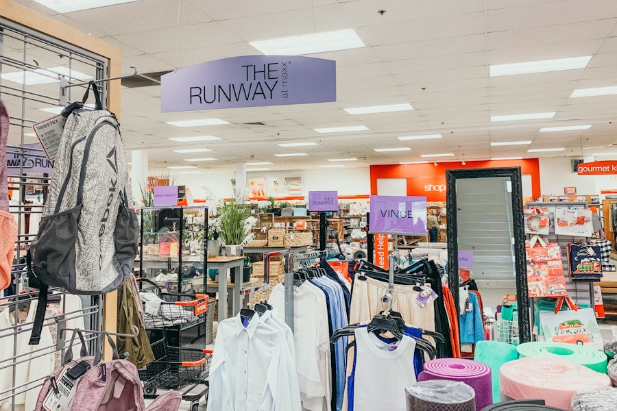 Interior of a TJ Maxx store Runway section showing signs for brands like Vince