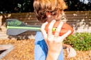 a person holding foam Nerf football outside