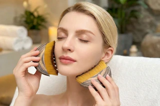 a woman using face brushes