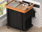a black and brown laundry hamper in front of a dryer
