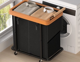 a black and brown laundry hamper in front of a dryer