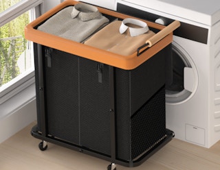 a black and brown laundry hamper in front of a dryer