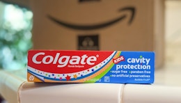 colgate cavity protection kids toothpaste on a counter in front of an amazon box