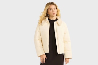 Woman model wearing a Free Assembly Short Puffer Jacket in the color "Vanilla Dream"